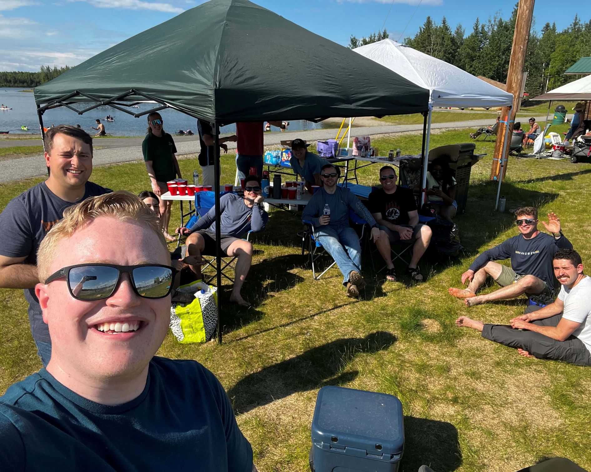 Group selfie of people at an outdoor Bar B Que event.